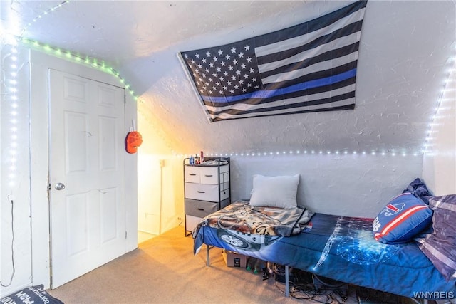 carpeted bedroom with a textured wall