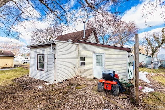 back of property featuring fence