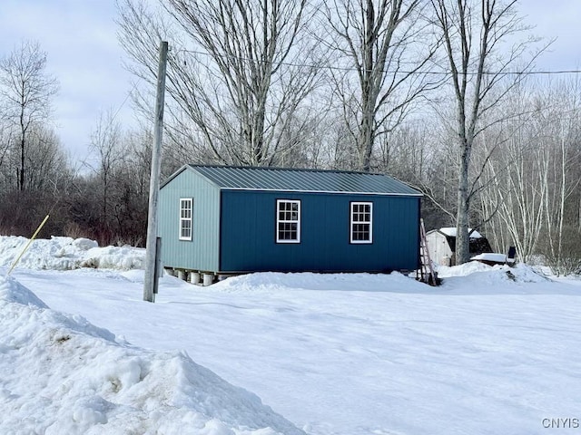 exterior space featuring an outbuilding and metal roof