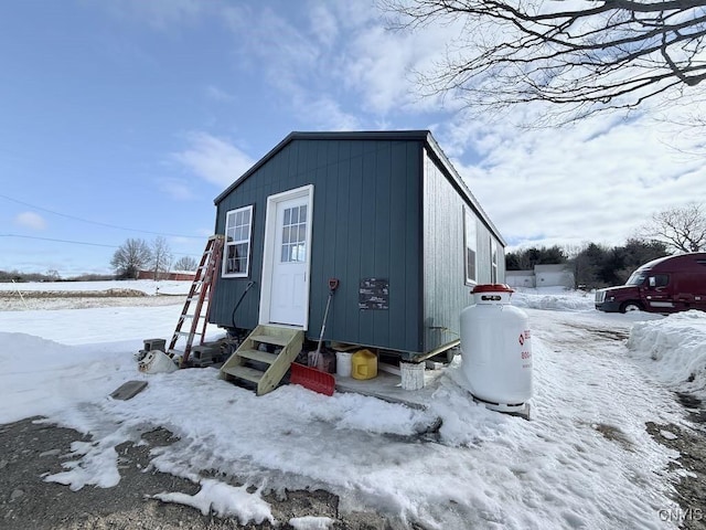 snow covered structure with entry steps