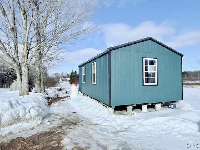 view of snow covered exterior featuring an outdoor structure