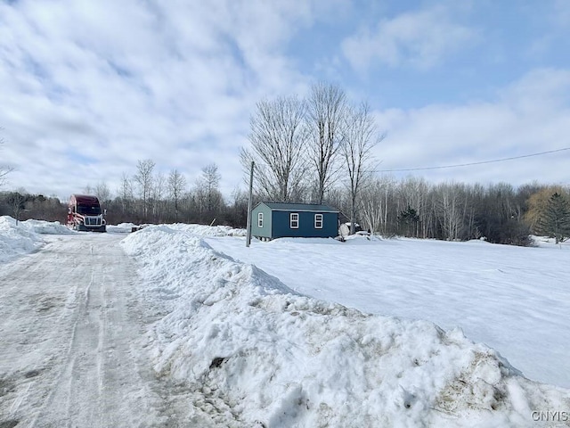 snowy yard with an outbuilding