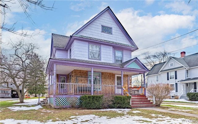 victorian home featuring a porch and roof with shingles