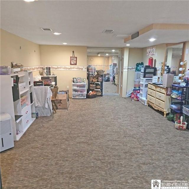 interior space with carpet flooring and visible vents