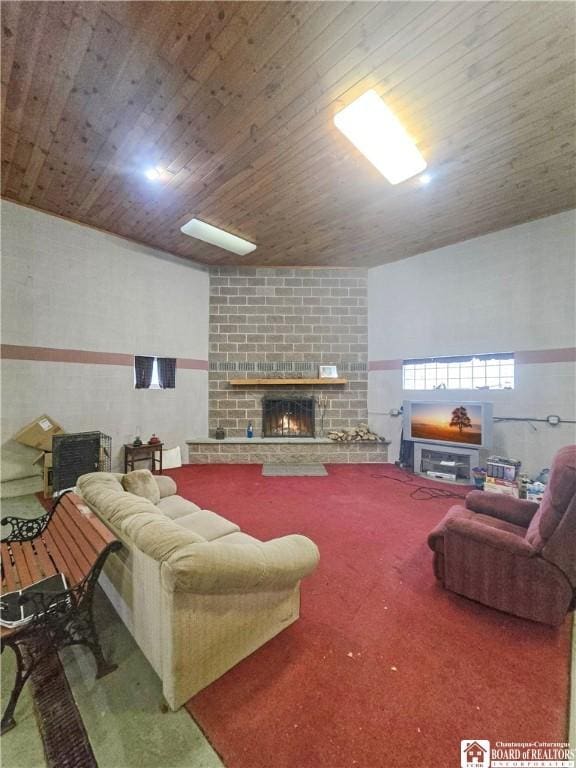 living area with carpet floors, a brick fireplace, and wood ceiling