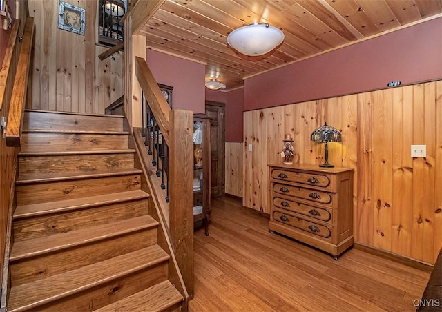 stairs with wooden ceiling and wood finished floors