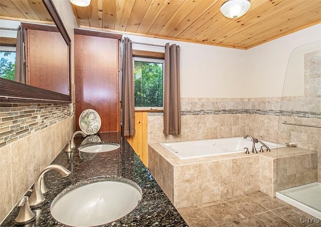 bathroom with wood ceiling, a garden tub, and a sink