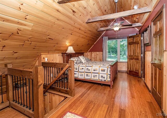 bedroom featuring vaulted ceiling with beams, wood ceiling, wooden walls, and wood finished floors