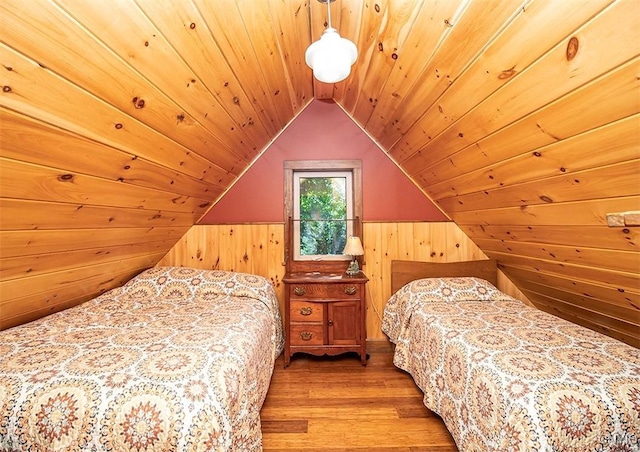 bedroom featuring lofted ceiling, wood walls, wood finished floors, and wood ceiling