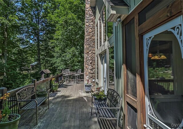 deck with outdoor dining area