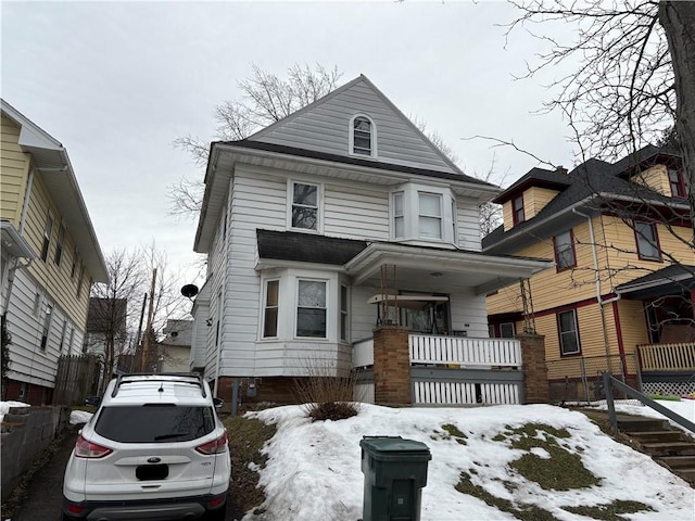 american foursquare style home with a porch