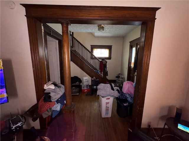 entryway featuring a textured ceiling, stairway, and hardwood / wood-style floors