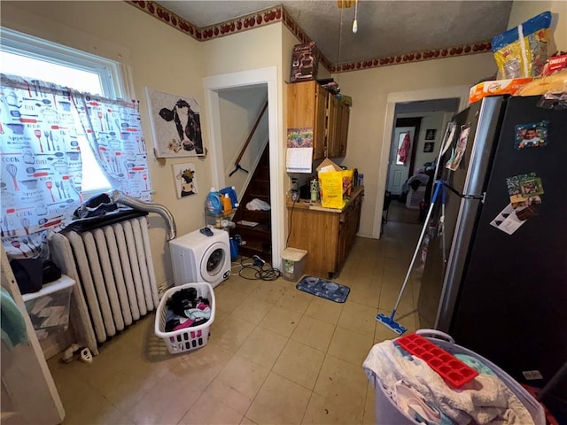 kitchen with brown cabinetry and freestanding refrigerator