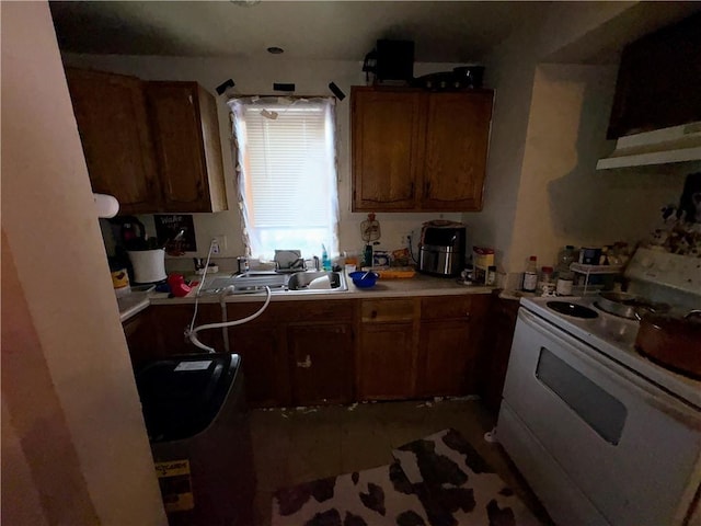 kitchen featuring light countertops, white range with electric stovetop, and brown cabinets