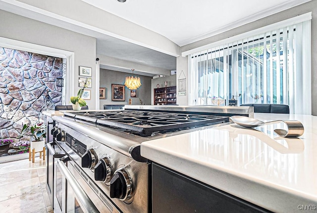 kitchen with high end stainless steel range and a notable chandelier