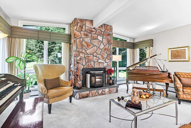 sitting room featuring plenty of natural light, carpet, and vaulted ceiling with beams