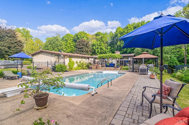 view of swimming pool with a patio area, fence, a fenced in pool, and a gazebo