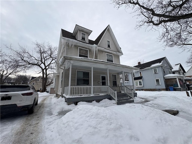 american foursquare style home with a porch