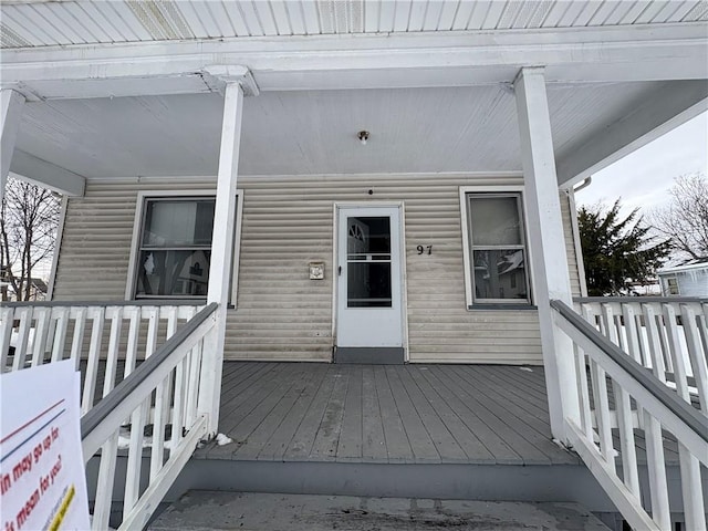 view of exterior entry featuring a wooden deck