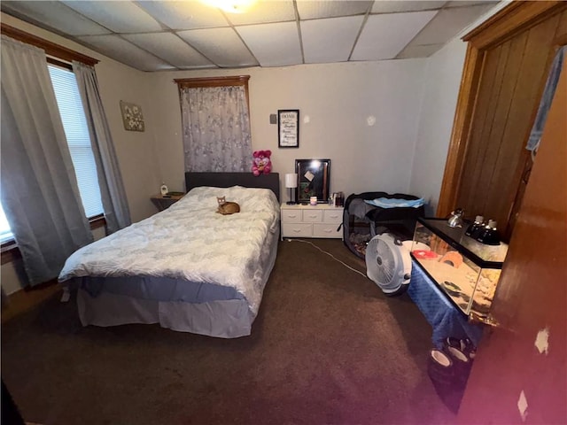 carpeted bedroom featuring a paneled ceiling