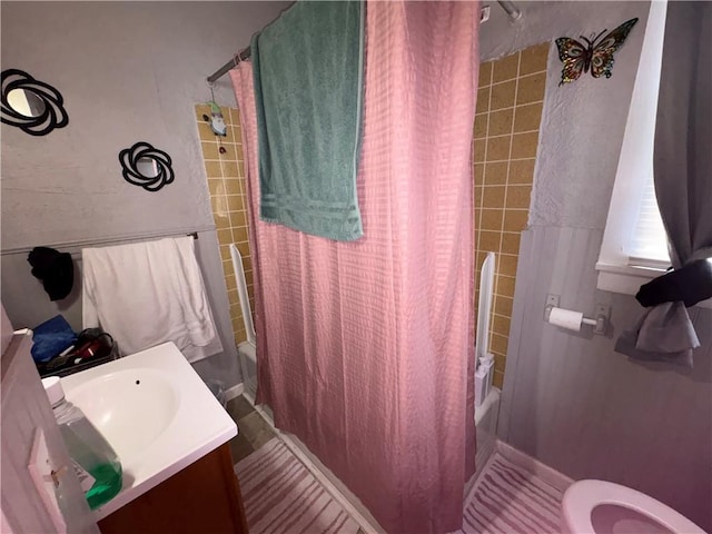 full bathroom featuring vanity, shower / bath combo with shower curtain, and toilet