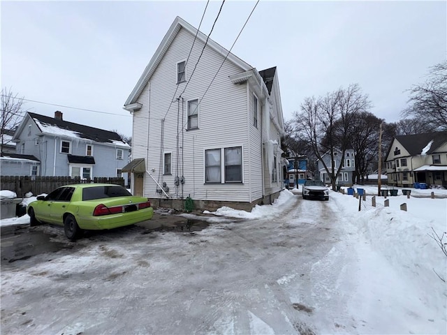 snow covered property featuring a residential view