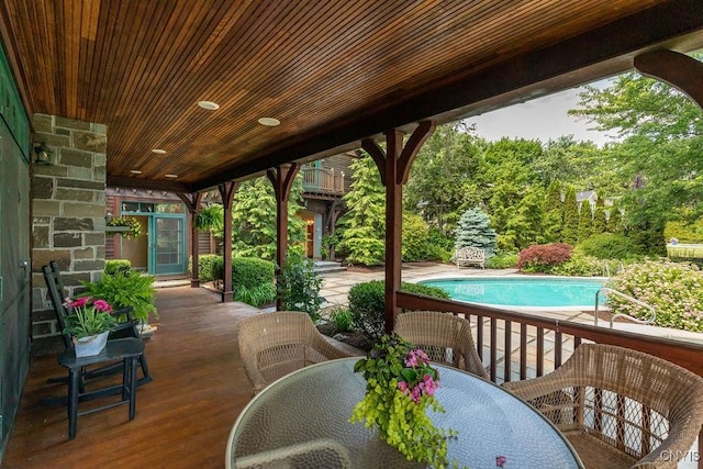 view of patio with outdoor dining space and an outdoor pool