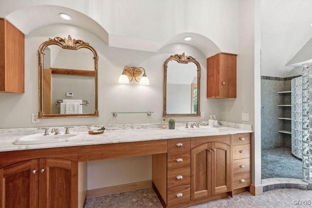 bathroom with walk in shower, a sink, and double vanity