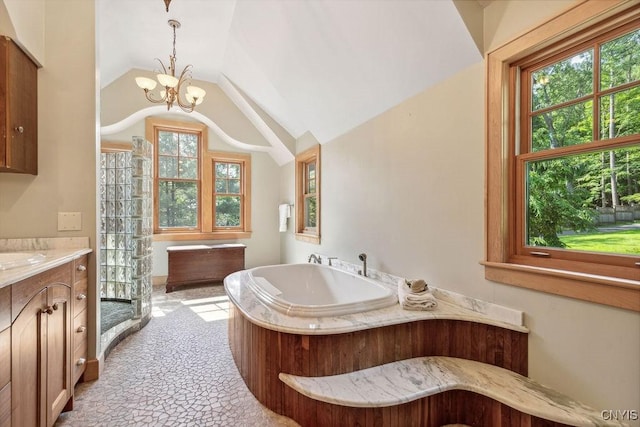 full bathroom featuring lofted ceiling, a chandelier, a garden tub, vanity, and walk in shower