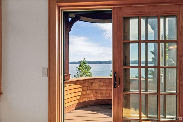 doorway to outside featuring a water view