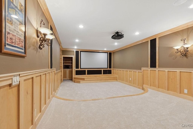 cinema featuring carpet, recessed lighting, a decorative wall, ornamental molding, and wainscoting