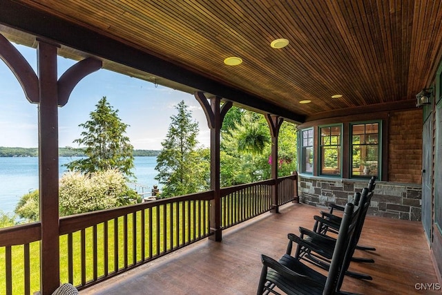 wooden deck featuring a water view and a porch