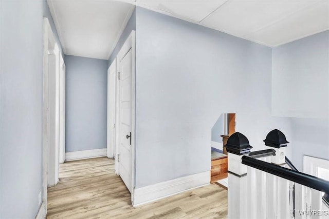 hallway featuring baseboards and wood finished floors