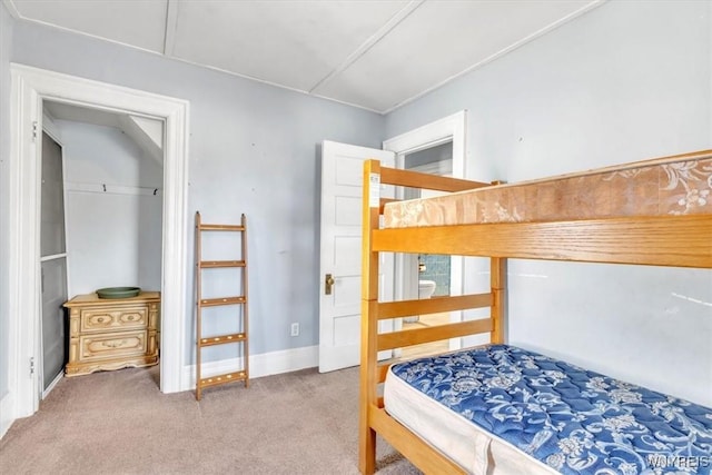 bedroom featuring carpet floors and baseboards