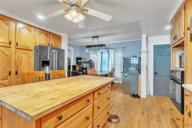 kitchen featuring stainless steel fridge with ice dispenser, light wood-style flooring, wood counters, ornamental molding, and oven