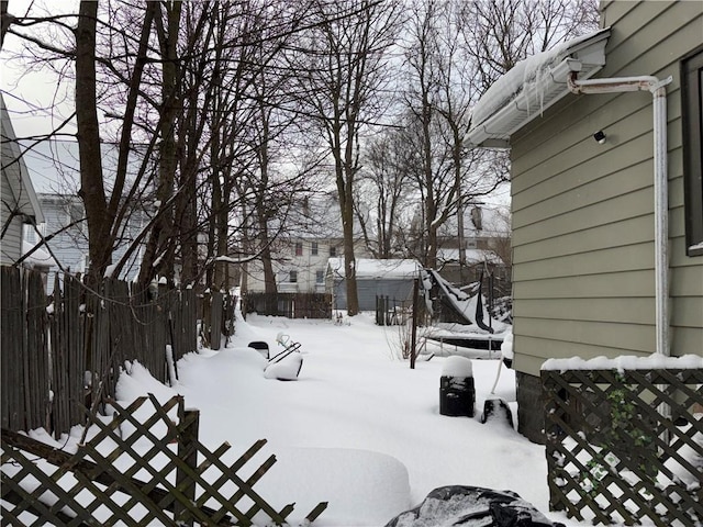 yard layered in snow with fence