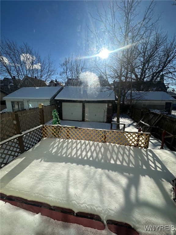 exterior space with a fenced backyard, driveway, and a wooden deck