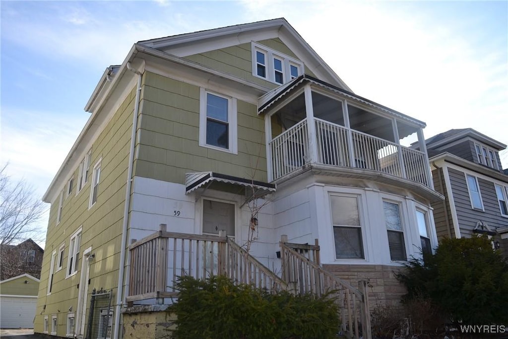 view of front of house with a garage and a balcony