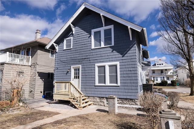 rear view of property featuring a chimney