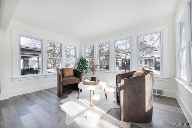 sunroom featuring a wealth of natural light and visible vents