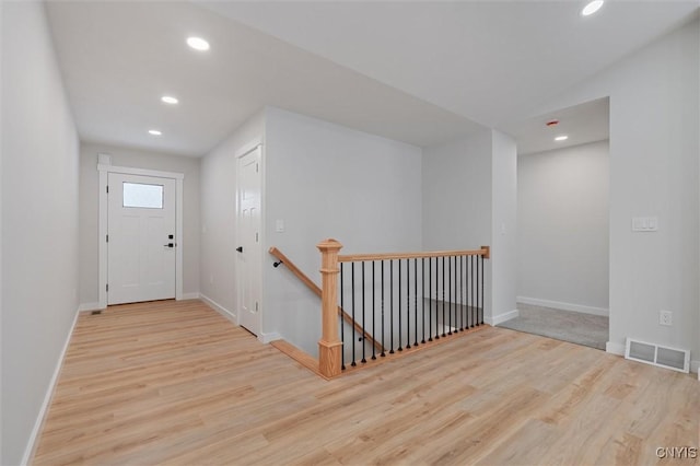 entryway featuring recessed lighting, visible vents, baseboards, and wood finished floors