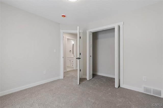 unfurnished bedroom featuring carpet floors, visible vents, and baseboards