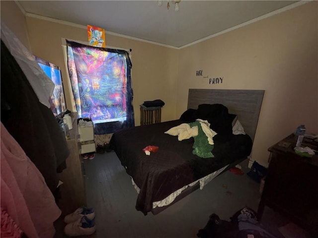 bedroom featuring wood finished floors and crown molding