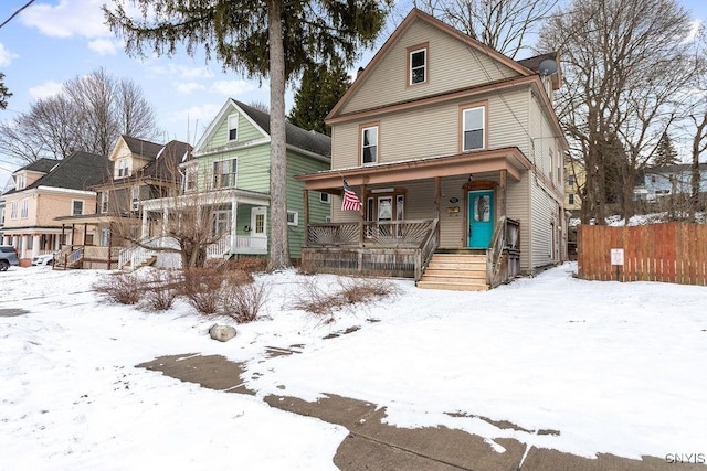 american foursquare style home featuring a porch