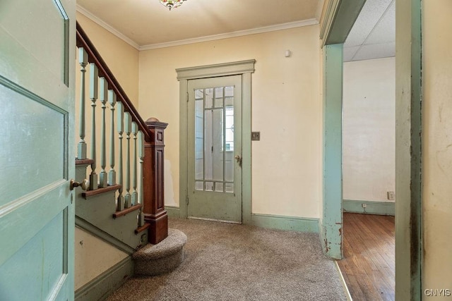 foyer entrance with baseboards, stairway, and crown molding