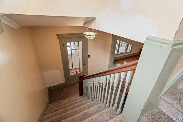 stairway featuring vaulted ceiling