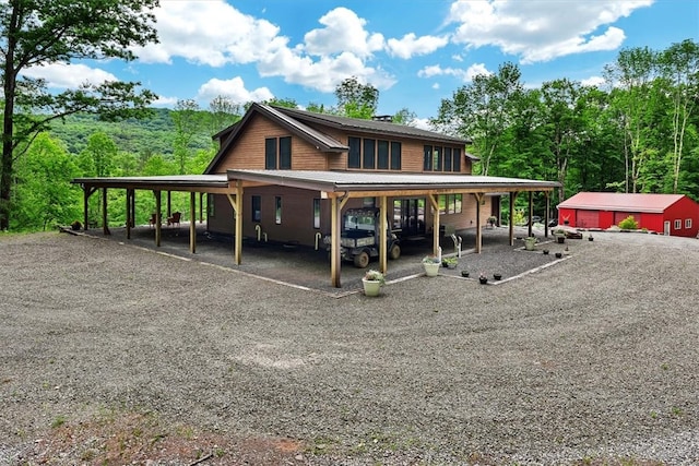 back of property featuring an attached carport and driveway