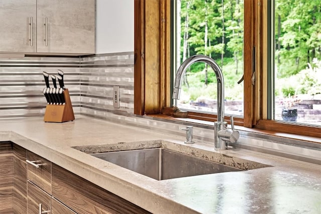 room details featuring decorative backsplash and a sink