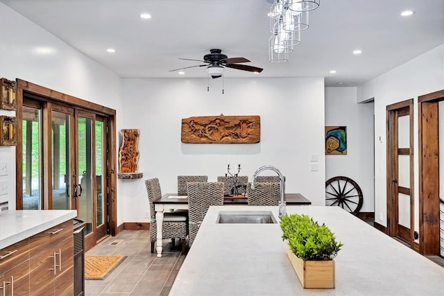 dining space with light tile patterned floors, baseboards, a ceiling fan, and recessed lighting