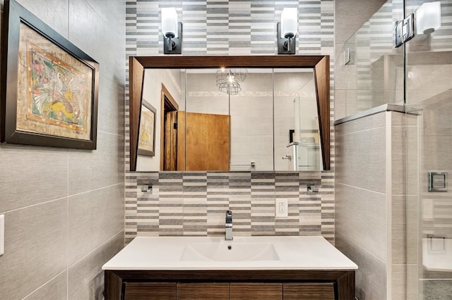 full bathroom featuring backsplash, a shower stall, vanity, and tile walls